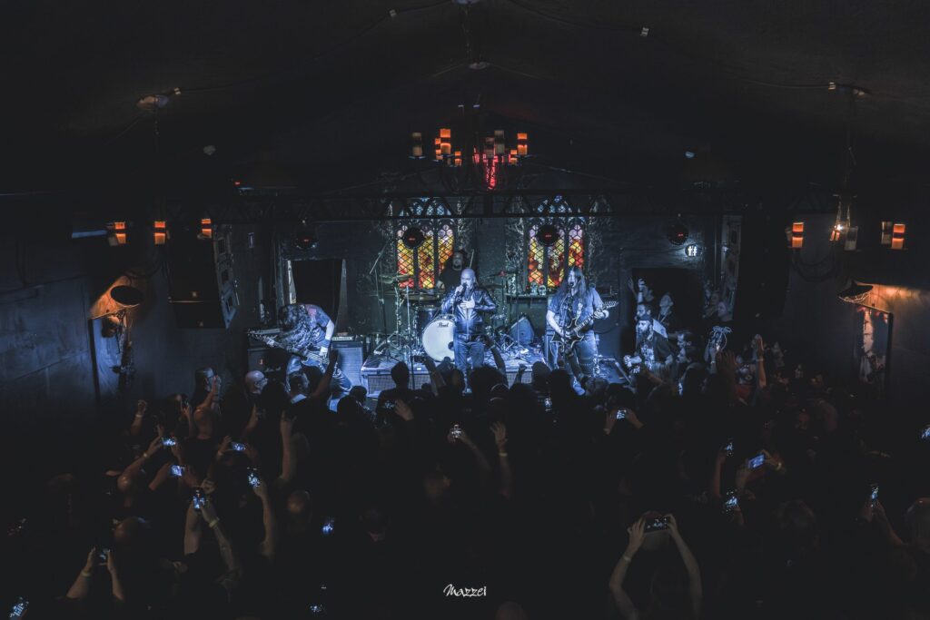 Disciple of Doom on stage at La Iglesia seen from the back of the crowd